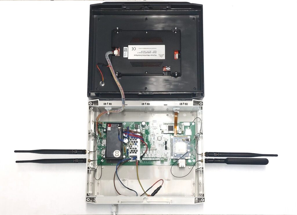 General view of the open device (like a suitcase or box) after all work inside has been completed. The battery is properly connected with cables, and all four antennas (two on each side) are screwed in place. The device is fully ready to be closed.