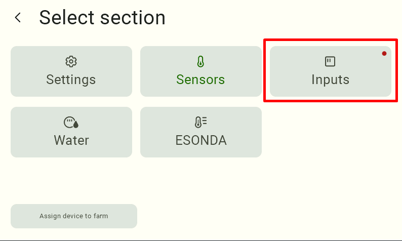 View of the menu panel. At the top left is the label "Select Section," with tiles below it for navigating to specific tabs.
In the first row, from left to right, are "Settings," "Sensors," and "Inputs." In the second row are “Water Meter” and “Esonda.” At the bottom left is the “Assign Device to Farm” tile. The “Input” tile is highlighted in red. In the center of the “Input” tile, in the upper-left corner, there is a red dot indicating an alarm.     