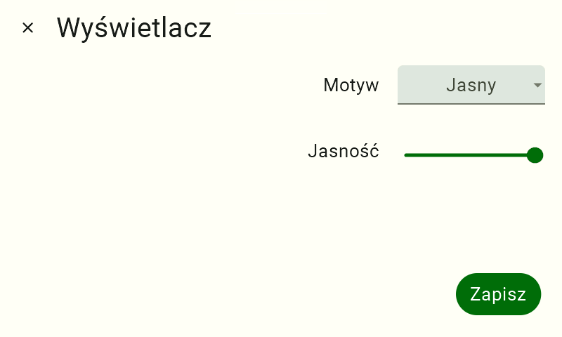Widok ustawień wyświetlacza FarmWatch Pro. W lewym górnym rogu widnieje nazwa "Wyświetlacz", po prawej stronie jest napis "Motyw", a po jego prawej kafelek zmiany motywy z napisem "Jasny". Poniżej napis "Jasność" a po jego prawej suwak z zieloną kropką ustawioną na suwaku maksymalnie do prawej.
W prawym dolnym rogu zielony przycisk z białym napisem "Zapisz". Ekran jest w motywie jasnym.