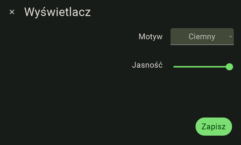 Widok ustawień wyświetlacza FarmWatch Pro. W lewym górnym rogu widnieje nazwa "Wyświetlacz", po prawej stronie jest napis "Motyw", a po jego prawej kafelek zmiany motywy z napisem "Ciemny". Poniżej napis "Jasność" a po jego prawej suwak z zieloną kropką ustawioną na suwaku maksymalnie do prawej.
W prawym dolnym rogu zielony przycisk z białym napisem "Zapisz". Ekran jest w motywie ciemnym.